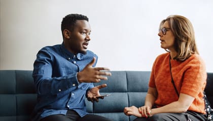 Two people, a man and a woman, talking.