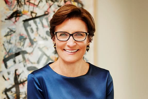 Jane Fraser, the Chief Executive Officer, Citigroup Inc., smiling, wearing a blue shirt and glasses